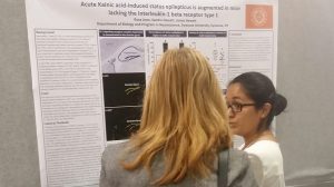Student explaining her poster to a faculty member.